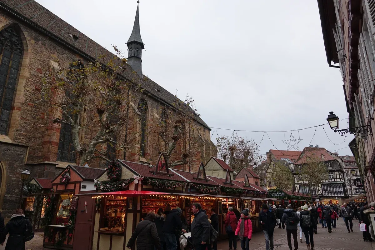 Christmas market chalets on Place des Dominicains beside the Dominican church in Colmar