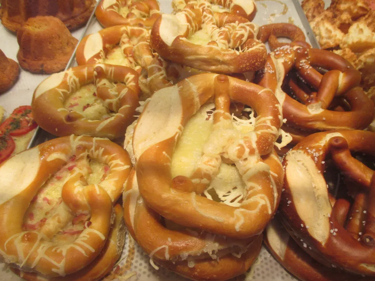 Pretzels topped with cheese in a baker's display in Alsace